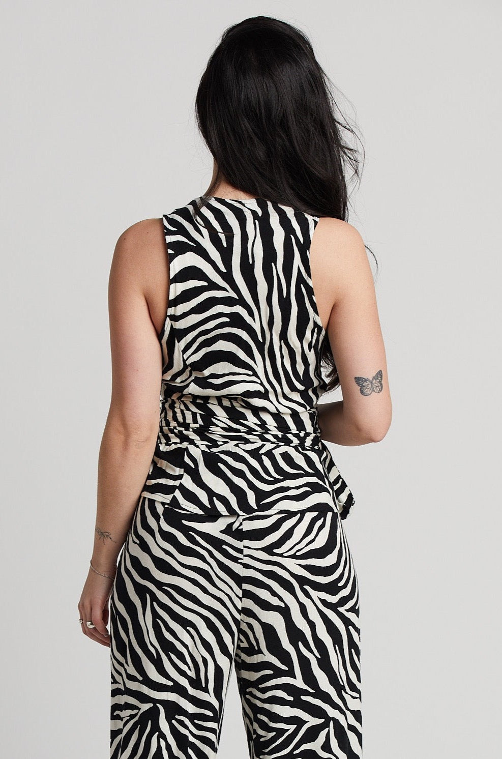 Remi sleeveless wrap top w/ sash & zebra motif